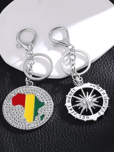 Detail of silver alloy keychain with rhinestone African map and Monet compass wheel charm