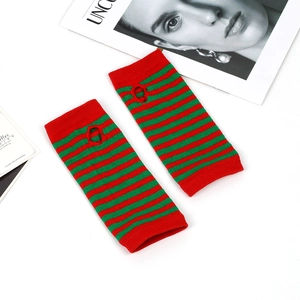 Detailed knit texture of red and green striped fingerless arm sleeves for costumes