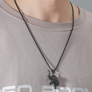 Close-up of black elephant pendant necklace with O-chain on male model neck