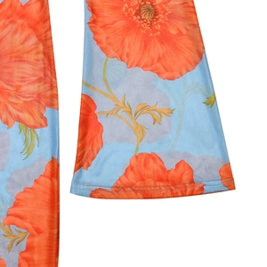 Detail of flared cuffs and vibrant orange poppy print on sheer blue mesh fabric