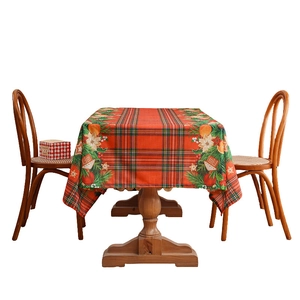 Vintage Christmas plaid tablecloth with festive patterns on a rustic wooden dining table