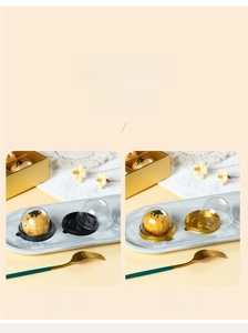 Close-up of clear dome pastry packaging available in black and gold base colors