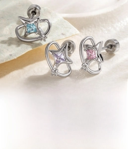Macro detail of star-shaped zircon earrings set in titanium steel with screw back studs