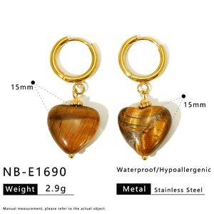 Detail view of heart-shaped tiger eye stone earrings with 15mm stainless steel gold frames