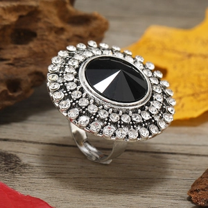 Adjustable silver ring featuring a large black round gem and white crystal halo