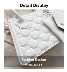Close-up of white quilted handbag with circular embossed pattern and mini pouch