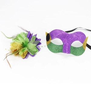 Detailed view of carnival mask and floral feather headpiece in purple green and gold