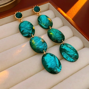 Vintage emerald green teardrop earrings with gold plating and needle stud design