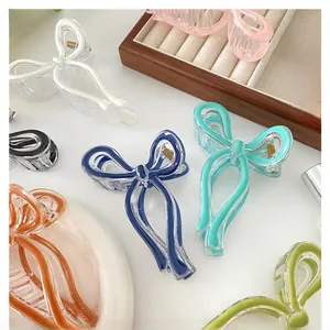 Various colors of bow-shaped hair claws made of jelly-colored acrylic with metal springs