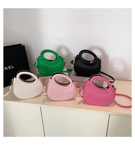 Detailed arrangement of textured pleated handbags in multiple colors with gold hardware