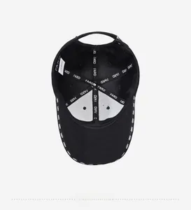 Detail view of the black baseball cap interior featuring branded tapes and metal buckle