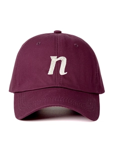Detail of burgundy cotton baseball cap with white embroidered n letter on front