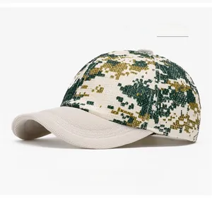Detail of military green digital camouflage baseball cap with beige peak and fabric texture