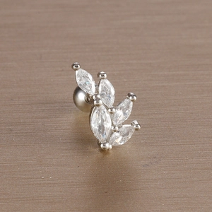 Macro detail of leaf-shaped stainless steel stud earring with marquise-cut zircons