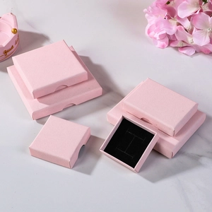 Elegant pink jewelry gift box set with black sponge lining on marble background