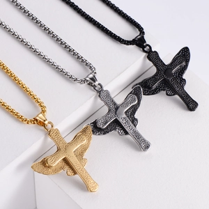 Detailed view of titanium steel eagle wing cross pendants in gold, silver, and black finish