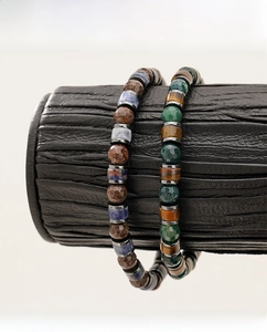 Detail of natural tiger eye and sodalite beaded bracelets for men on a display stand