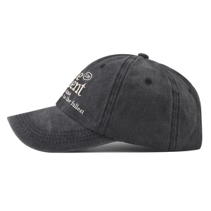 Detail of the side cream embroidery on a vintage washed charcoal grey baseball cap