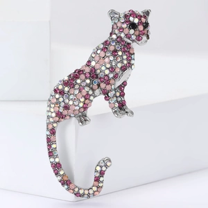 Detailed view of silver alloy leopard brooch with sparkling pink and purple crystals