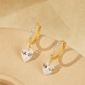 Macro shot of S925 silver hoop earrings with heart-shaped sparkling zircon drop