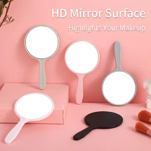 Mini round handheld makeup mirrors in pink, white, black, and grey with ergonomic handle
