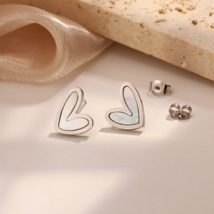 Elegant heart-shaped stud earrings with white mother of pearl inlay in silver finish