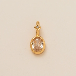 Detailed view of an oval champagne gemstone pendant in a gold-tone flower necklace setting