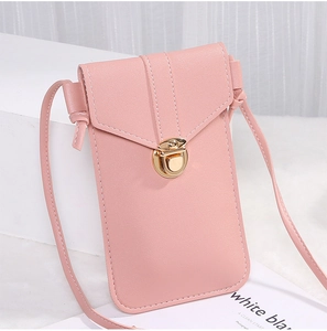 Detailed side view of pink faux leather crossbody phone bag with gold hardware buckle