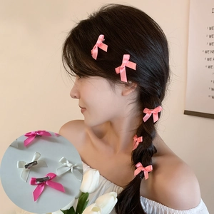 Detail of 4cm satin bow hair clips showing smooth ribbon texture and silver metal back clips
