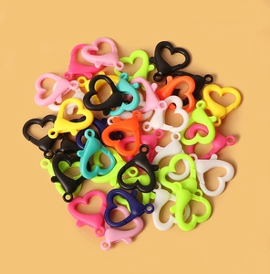 Close-up of colorful heart-shaped acrylic lobster clasps for DIY jewelry making