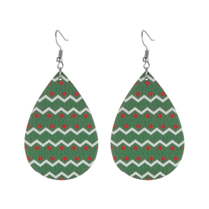 Detailed view of green faux leather teardrop earrings with red and white wavy patterns