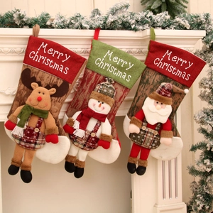 Three oversized Christmas stockings with Santa, snowman and reindeer on a white fireplace