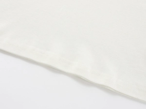 Close-up of premium white Tencel wool fabric showing delicate texture and fine stitching
