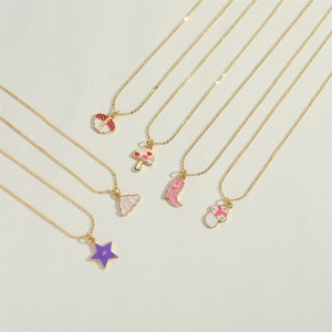 Detail view of colorful enamel star and mushroom charms on delicate gold chains