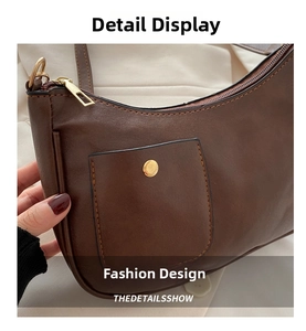 Close-up of dark brown leather texture with golden magnetic snap and metal zipper details