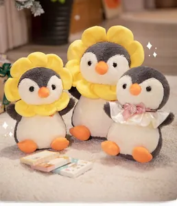 Detailed view of plush penguin toys with sunflower headbands and lace bows on a soft rug