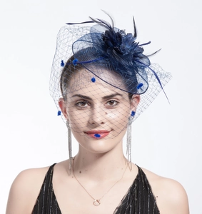 Detail of dark blue bridal fascinator hat with elegant feathers and mesh floral veil