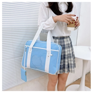 Sky blue JK travel bag featuring a heart-shaped clear window and small side pouch