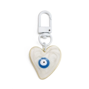 Detailed view of a heart-shaped evil eye keychain with blue resin and gold metal trim