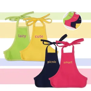 Detail of four colorful pet bibs in green, yellow, blue, and pink with text prints