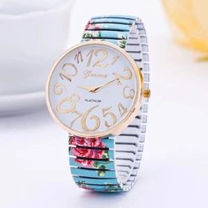 Detailed macro view of white watch face with gold numerals and floral stretch band