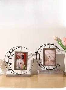 Modern moon-shaped metal photo frames with wooden base and intricate leaf and star details