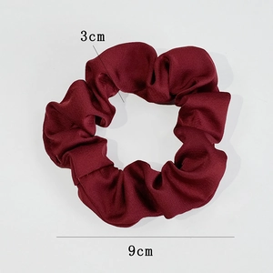 Detail view of burgundy satin scrunchie showing 9cm outer diameter and 3cm width dimensions