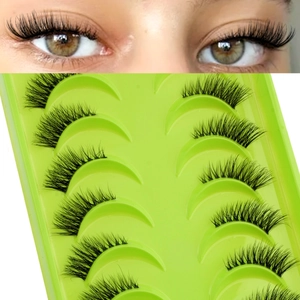 Detailed view of 10 pairs of dense natural false eyelashes on a green display tray