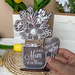 Detail of wooden flower vase decor with Mother's Day engraving and rustic heart tag