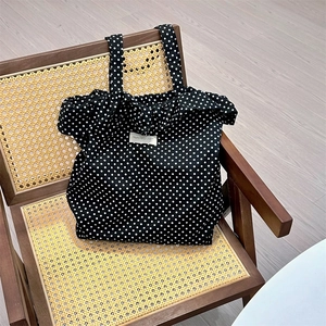 Polka dot canvas tote bag shown on a vintage wicker chair for a stylish aesthetic look