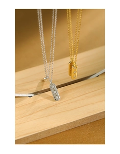 Detail of silver and gold bar necklaces with three star-shaped zircon stones in close-up