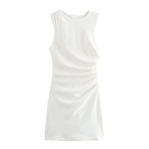 Detail of the side ruching and pleated design on a white sleeveless knit mini dress