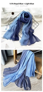 Detail of pleated silk scarf with blue gradient texture and artistic flat lay display