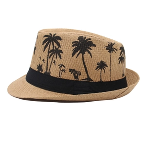 Detail of khaki panama hat featuring black palm tree prints and a wide woven band